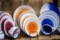 different-colored porcelain cups, plates and saucers are on the counter Royalty Free Stock Photo