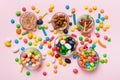 different colored round candy in bowl and jars. Top view of large variety sweets and candies with copy space Royalty Free Stock Photo