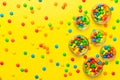 different colored round candy in bowl and jars. Top view of large variety sweets and candies with copy space Royalty Free Stock Photo