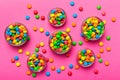 different colored round candy in bowl and jars. Top view of large variety sweets and candies with copy space Royalty Free Stock Photo