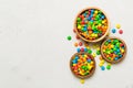 different colored round candy in bowl and jars. Top view of large variety sweets and candies with copy space Royalty Free Stock Photo