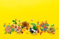 different colored round candy in bowl and jars. Top view of large variety sweets and candies with copy space Royalty Free Stock Photo