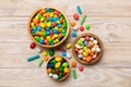 different colored round candy in bowl and jars. Top view of large variety sweets and candies with copy space Royalty Free Stock Photo