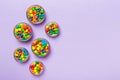 different colored round candy in bowl and jars. Top view of large variety sweets and candies with copy space Royalty Free Stock Photo