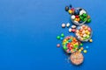 different colored round candy in bowl and jars. Top view of large variety sweets and candies with copy space Royalty Free Stock Photo