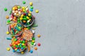 different colored round candy in bowl and jars. Top view of large variety sweets and candies with copy space Royalty Free Stock Photo