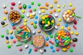 different colored round candy in bowl and jars. Top view of large variety sweets and candies with copy space Royalty Free Stock Photo