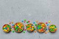 different colored round candy in bowl and jars. Top view of large variety sweets and candies with copy space Royalty Free Stock Photo