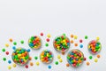 different colored round candy in bowl and jars. Top view of large variety sweets and candies with copy space Royalty Free Stock Photo