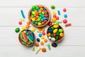 different colored round candy in bowl and jars. Top view of large variety sweets and candies with copy space Royalty Free Stock Photo