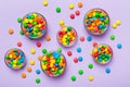 different colored round candy in bowl and jars. Top view of large variety sweets and candies with copy space Royalty Free Stock Photo