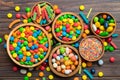 different colored round candy in bowl and jars. Top view of large variety sweets and candies with copy space Royalty Free Stock Photo