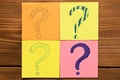 Different colored stickers with questions on wooden background. Concept of idea development Royalty Free Stock Photo