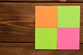 Different colored stickers on a wooden background. Empty text space Royalty Free Stock Photo