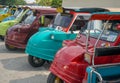 Different colored tuk tuks lined up