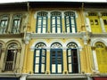 Different colored windows on the facade of a colonial style building in Singapore Royalty Free Stock Photo