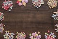 Different colorful beads on the brown wooden table Royalty Free Stock Photo