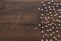 Different colorful beads on the brown wooden table Royalty Free Stock Photo