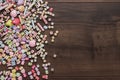 Different colorful beads on the brown wooden table Royalty Free Stock Photo