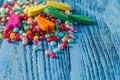 Different colorful beads on the wooden table Royalty Free Stock Photo