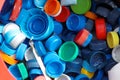 Different colorful bottle caps, top view. Plastic recycling Royalty Free Stock Photo
