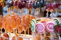 Different colorful candy canes caramel on stick. Lollipop on stick in sweets shop window