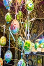 Different colorful painted Easter eggs on the tree at traditional European market Royalty Free Stock Photo