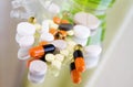 Different colorful pills and medicines on a mirror