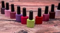 Different colorful small nail polish bottles on wooden Royalty Free Stock Photo