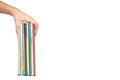 Different colorfull books in stack with hand isolated on white background, copy space template Royalty Free Stock Photo