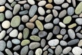 Different colourful small sea stones isolated on black background. Background of sea stones. Ocean stones isolated
