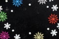Different colors and different sizes of snowflakes lie on a black background.Abstract texture. Royalty Free Stock Photo