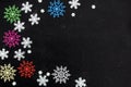 Different colors and different sizes of snowflakes lie on a black background.Abstract texture. Royalty Free Stock Photo