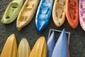 Different colors kayaks sorted on the beach at sunset.