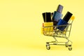 Different colors of nail polishes in a shopping trolley on a yellow background Royalty Free Stock Photo