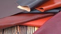 Natural leather textures samples on dark wooden background Royalty Free Stock Photo