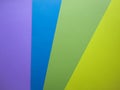 Different colors paper top view abstract background. Violet, blue, green and yellow cardboard paper sheets Royalty Free Stock Photo