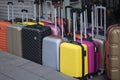Different colors of suitcases for sale in front of the street Royalty Free Stock Photo