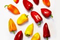 Different colors sweet peppers laid out on a white surface Royalty Free Stock Photo