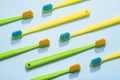 Different colors toothbrushes, green and yellow on a blue background Royalty Free Stock Photo