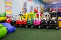 Different colourful toy cars are standing in children entertainment center in a line. Games for small kids. Royalty Free Stock Photo