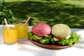 Different colours of burgers and orange juice Royalty Free Stock Photo