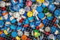 Different colours of plastic plugs recycling in the net Royalty Free Stock Photo