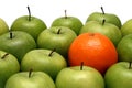 Different concepts - orange between apples Royalty Free Stock Photo