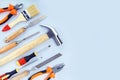 Different construction tools for home renovation on grey background with copy space.