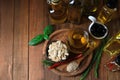 Different cooking oils and ingredients on wooden table, flat lay. Space for text Royalty Free Stock Photo
