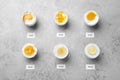 Different cooking time and readiness stages of boiled chicken eggs on light grey table, flat lay Royalty Free Stock Photo