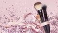 Different Cosmetic makeup brushes with pink ribbon and holographic glitter confetti in the form of stars on pink background Flat Royalty Free Stock Photo