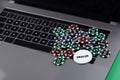 Different of cost casino chips stacking on a laptop. Dealer. Bet at game and win Royalty Free Stock Photo