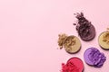 Different crushed eye shadows on pink background, flat lay. Space for text Royalty Free Stock Photo